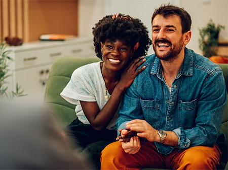 A couple on a couch during a therapy meeting