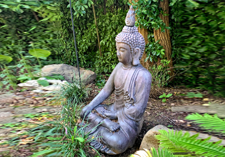 A statue in a peaceful forest setting